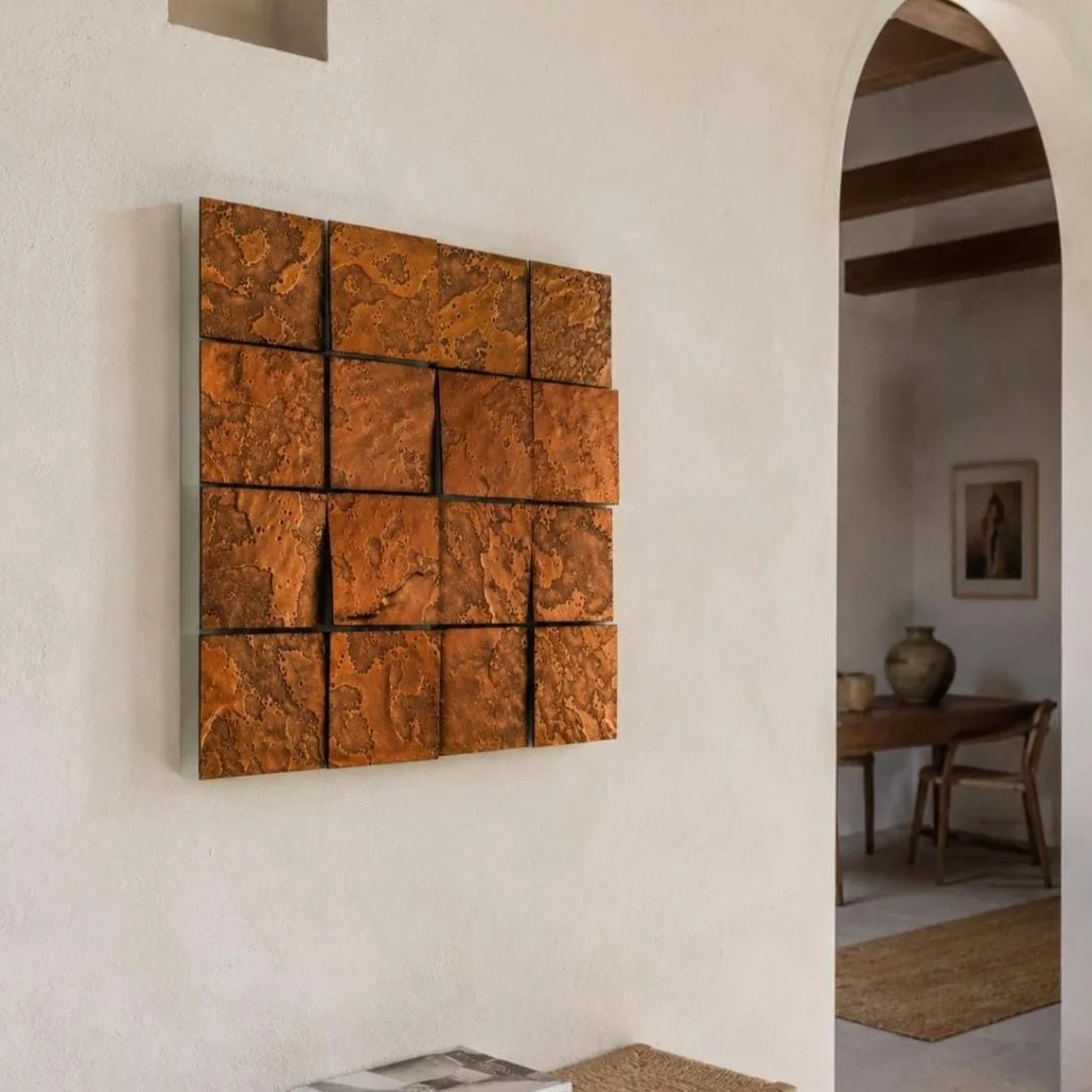 A copper Aurora switched off, seen from the edge, sixteen tiles at different heights